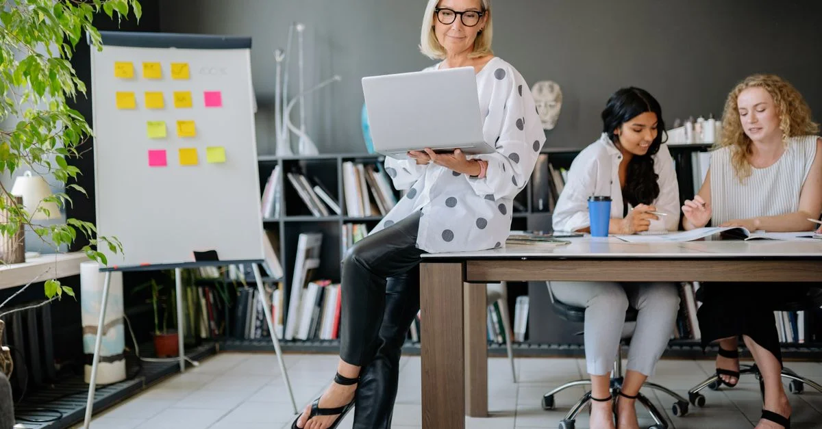 Des femmes diverses collaborant dans un bureau stylé avec des technologies et des outils de brainstorming.